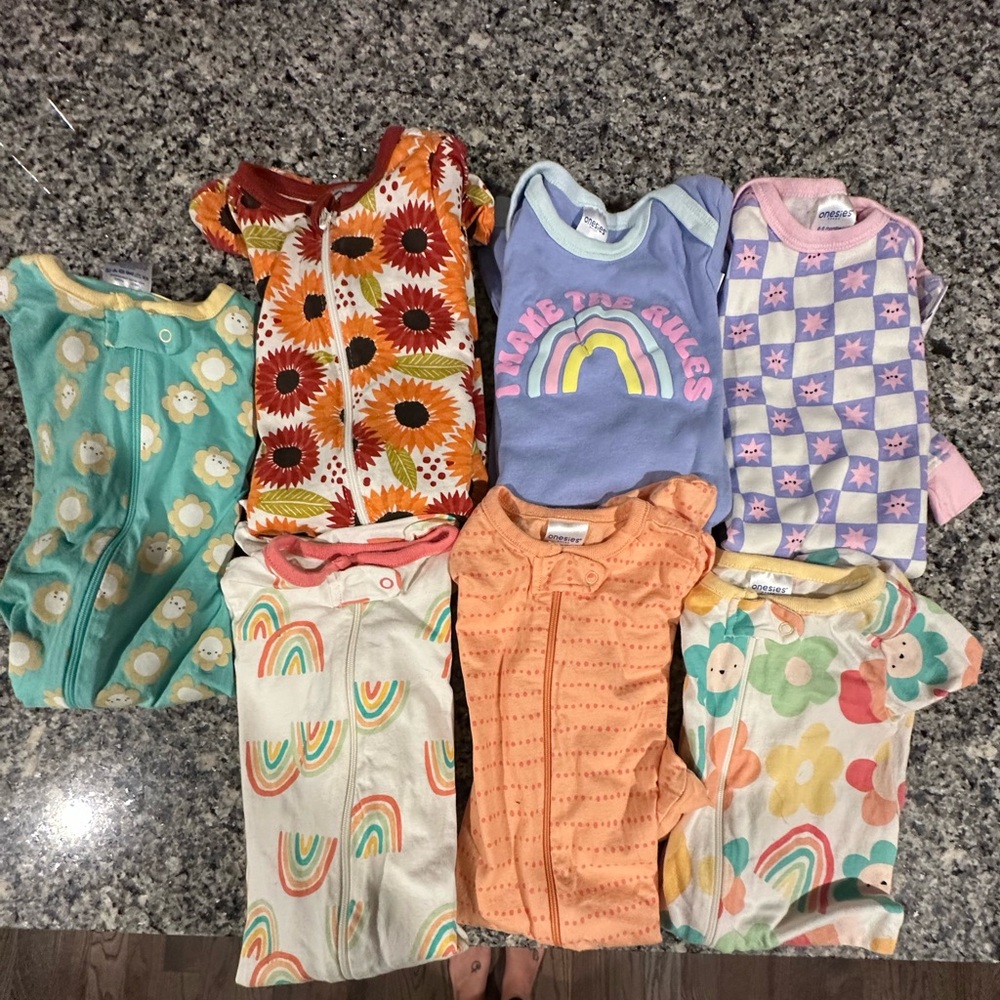 7 size 6-9 months onesie pj's.Tags were taken off but not one of them were worn.